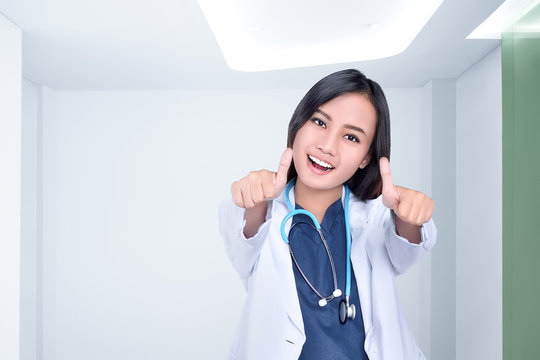 Beautiful Asian Female Doctor In White Coat Showing Thumbs Up