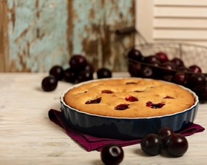 Rustic style. Homemade plum cake on a purple linen napkin.