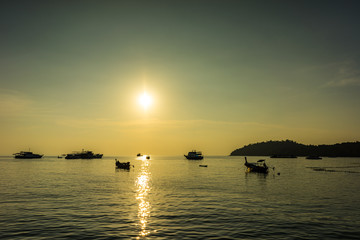 Silhouette fishing boat and sunset sky on Pattaya beach, Koh Lipe, Satoon province, Thailand.