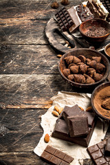 Chocolate bars with truffles and cocoa powder.