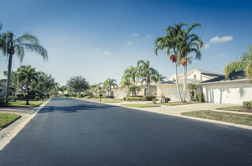 Fototapeta premium Gated community houses and empty asphalt road, South Florida, United States