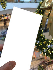 Naklejka na ściany i meble hands hold cheque bill white paper on shopping mall background.