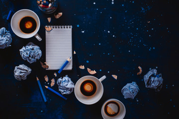 Creative writing concept with linded note paper, empty coffee cups, pencils and crumpled paper balls on a dark background. Editing and copywriting workplace. - obrazy, fototapety, plakaty
