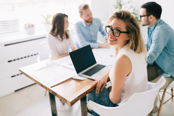 Group of architects and designers working and collaborating on project