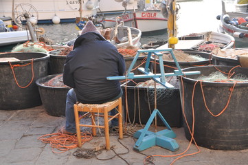fishermen repairing the fishing net in Camogli harbor, Genoa Province, Liguria, Italy © Simo