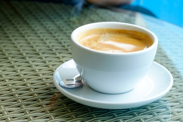 Hot coffee in a glass of coffee on a glass table.