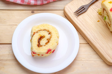 Sliced Cake Roll on wooden background