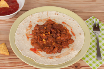 Chili Con Carne on tortilla wrap with salsa sauce and tortilla chips