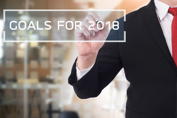 Goal 2018concept, Businessman pointing on text. Business new year card concept.