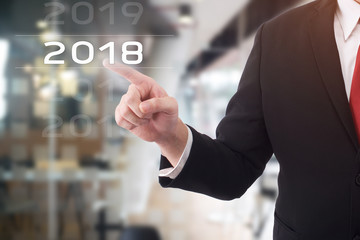 Businessman pointing year 2018 welcome year 2018. Business new year card concept