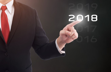 Businessman pointing year 2018 welcome year 2018. Business new year card concept