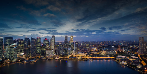 Fototapeta na wymiar modern buildings illuminated in Singapore downtown at dusk
