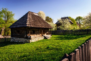 Fototapeta na wymiar Small charming cottage with traditional wooden architecture of rural Romania