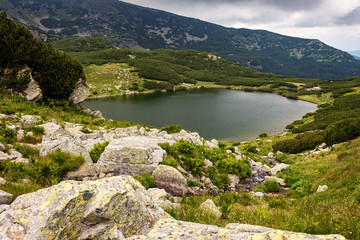Naklejka na ściany i meble Glacial lake high in the Carpathian mountains during a beautiful summer day