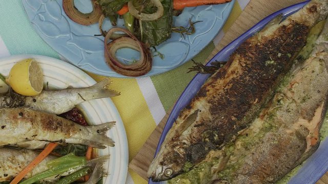 Man hands peeling skin from fried Lake Ohrid trout