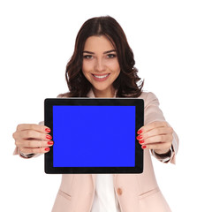 smiling young business woman showing blank screen of a tablet