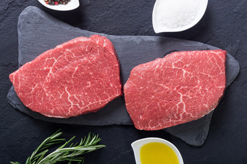 Raw beef steak with rosemary