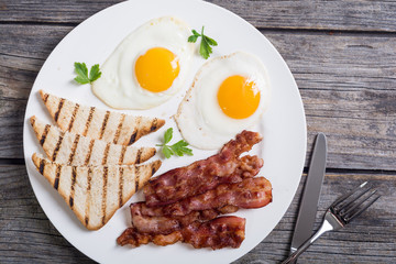 Breakfast with eggs bacon and toasts