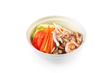 vegetables with seafood in a plate on a white background isolated