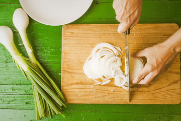 Girl cutting fresh onions