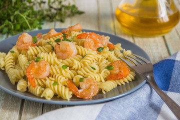 Italian pasta fusilli with shrimps and thyme