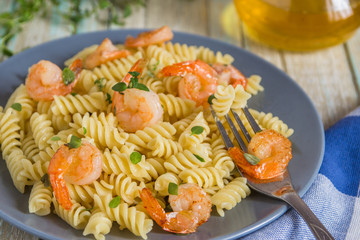 Italian pasta fusilli with shrimps and thyme