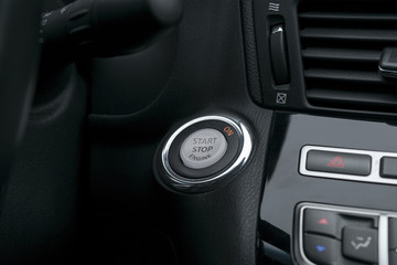 Car dashboard with focus on engine start stop button, Modern car interior details. start/stop