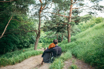 couple resting on trail and hugging each other