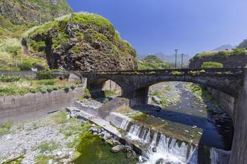 An old bridge crosses a river in the small village of Sao Vicente in Madeira, Portugal.