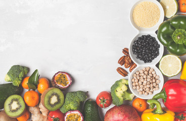 Healthy vegan food concept. Fruits vegetables background. Fresh vegetables, exotic and seasonal fruits, cereals, nuts and beans for a vegetarian diet, top view. Copy space, frame background.