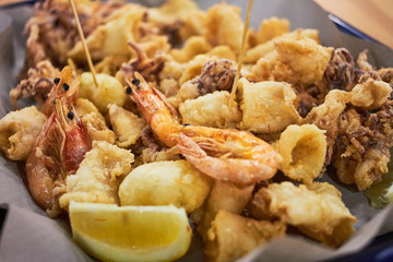 A typical Italian dish fried seafood: shrimp, squid, octopus and a slice of lemon. Italian fast...