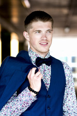 portrait of an attractive smiling man in a blue suit