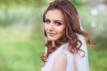 Close up portrait of beautiful bride in the park