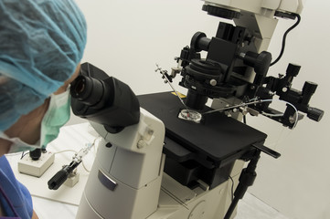 female doctor working with scientific microscope