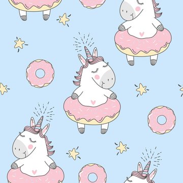 Vector seamless pattern with cute cartoon unicorn and donuts © Daria