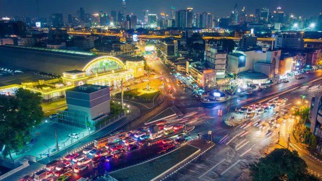 Bangkok night skyline. Aerial cityscape. Time lapse with traffic and blurred traces from cars. Zoom effect