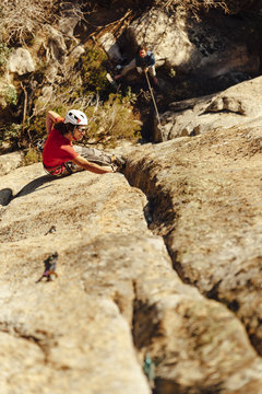 Rock climber ascending a steep granite crack