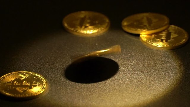 Bitcoin revolves on black background. Slow motion