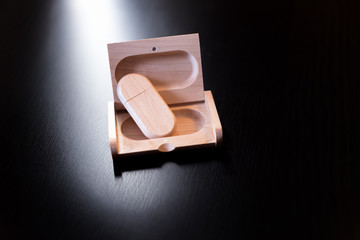 wooden usb flash drive on a black table