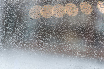 Rain. Autumn seasonal background with rain drops on the window. Autumn cold weather with rain and wind. Abstract colorful background.
