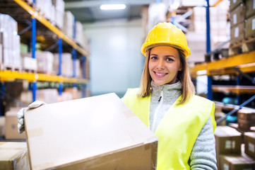 Female warehouse worker loading boxes.