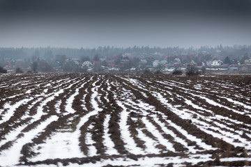 Melting snow on the plowed field