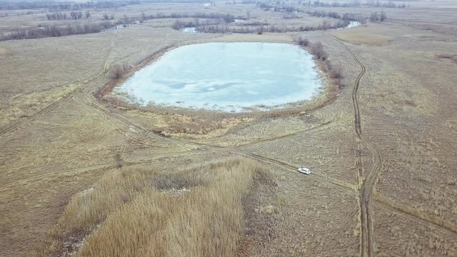 aerial view of the frozen lake in the winter field
