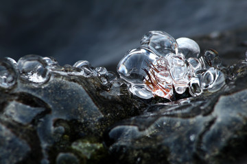 Natural, clear ice on stone at Loimijoki river, Forssa, Finland. 