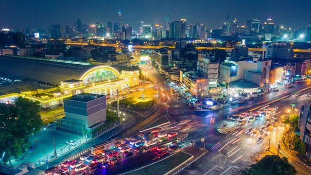 Bangkok night skyline. Aerial cityscape. Time lapse with traffic and blurred traces from cars. Zoom out effect