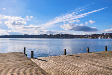 Fototapeta na wymiar Empty wooden pier on Lake Starnberg in Bavaria, Germany