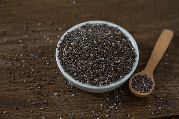 Chia seeds on dark wooden surface