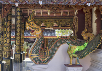 Fototapeta premium Dragon and peacock statues at a Buddhist temple near Chiang Mai