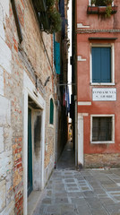 Fototapeta na wymiar Venice, Italy - August 14, 2017: The narrow cozy streets of Venice.