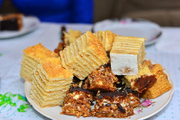 Pieces of homemade apple cake on a baking grid over a wooden table, copy space, selected focus, very narrow depth of field